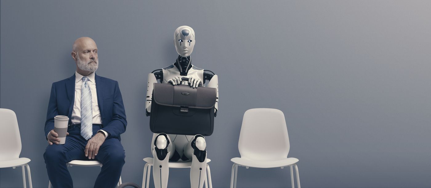 A humanoid robot with a briefcase waiting beside a man in a suit